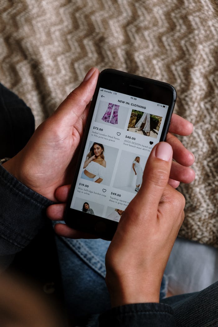 services-02 Close-up of a person shopping for clothing on a smartphone, highlighting the modern digital lifestyle.
