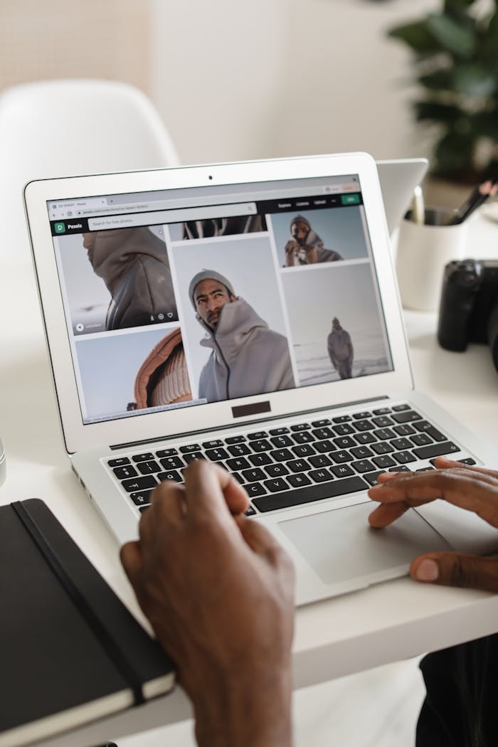 gallery-1 Person browsing travel photos on laptop at a modern indoor workspace.